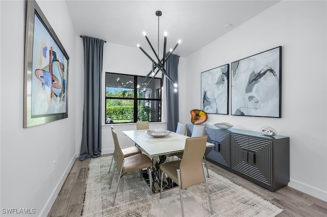 dining room with an inviting chandelier and light hardwood / wood-style floors