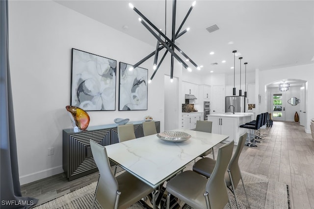 dining area featuring a chandelier and dark wood-type flooring