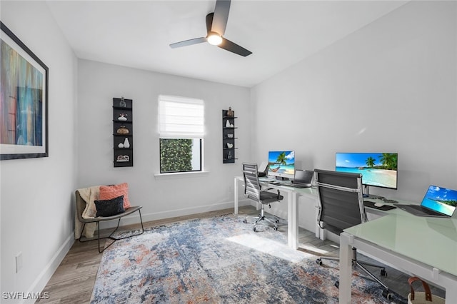 home office featuring light wood-type flooring and ceiling fan