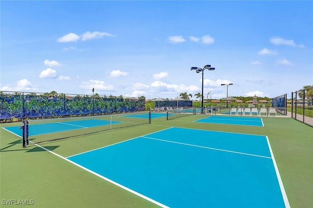 view of tennis court featuring basketball court