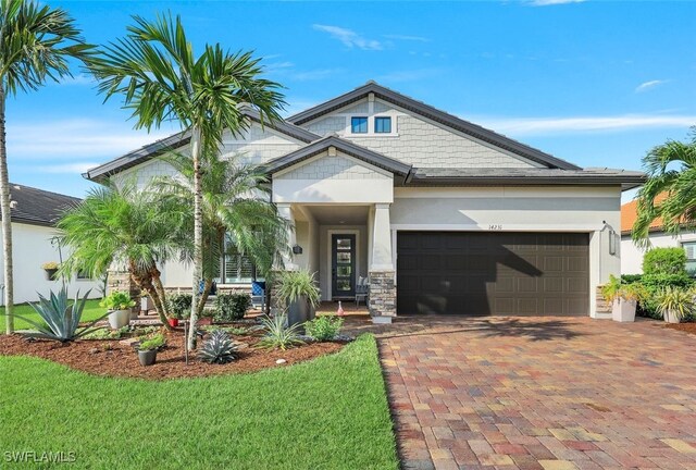 craftsman house featuring a front yard and a garage