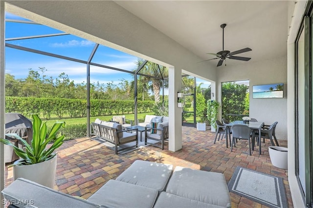 view of patio with ceiling fan, a lanai, and an outdoor hangout area