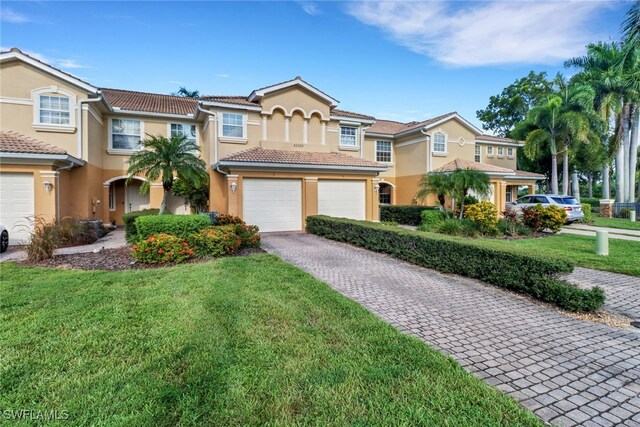 view of property with a front lawn and a garage