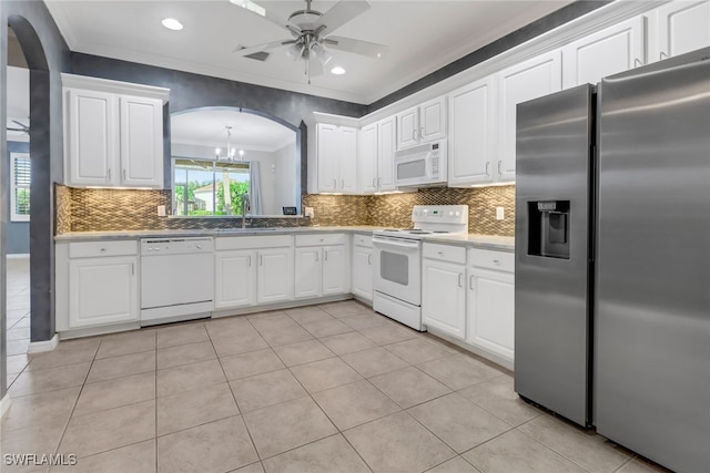 kitchen with white cabinets, ceiling fan with notable chandelier, tasteful backsplash, and white appliances