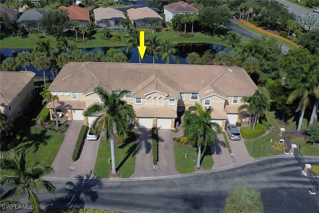 birds eye view of property with a water view and a residential view