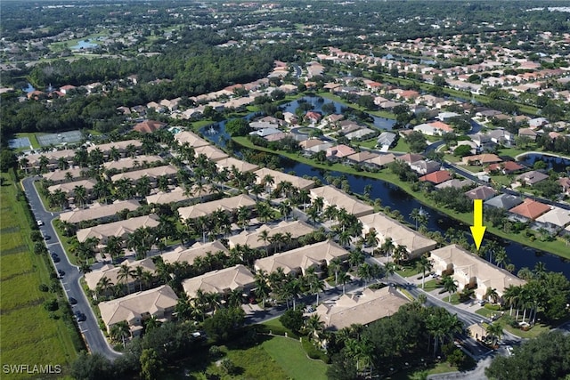 drone / aerial view with a water view and a residential view