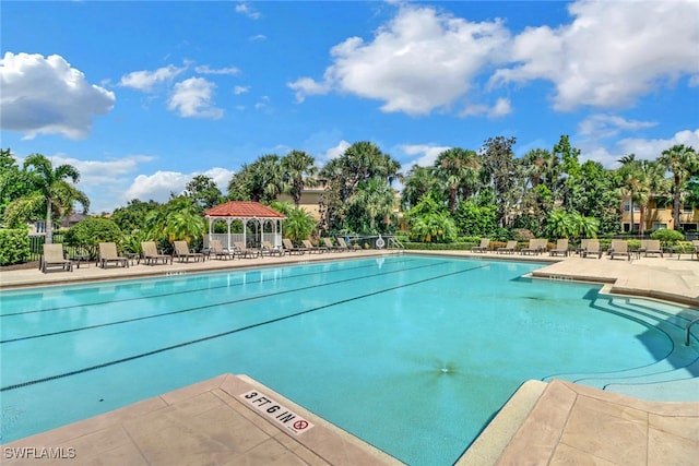 community pool featuring a gazebo, a patio area, and fence