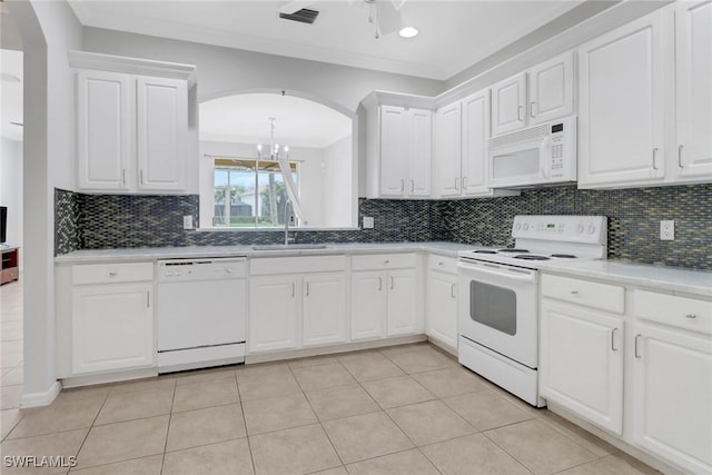 kitchen featuring white appliances, white cabinetry, and a sink