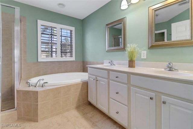 full bath with a stall shower, a garden tub, a sink, and tile patterned floors