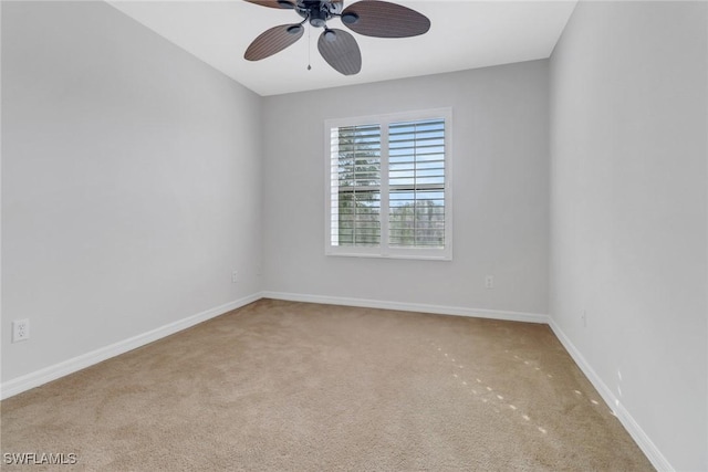 unfurnished room featuring carpet floors, baseboards, and a ceiling fan