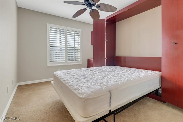 bedroom with a ceiling fan, carpet flooring, and baseboards