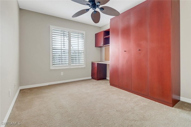 unfurnished bedroom with carpet floors, baseboards, and a ceiling fan