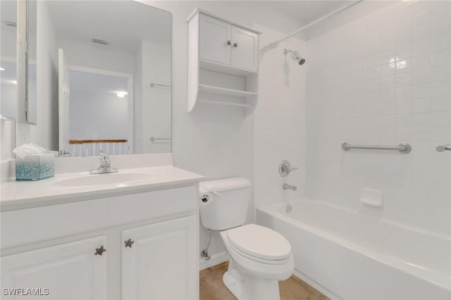 bathroom with bathtub / shower combination, vanity, and toilet