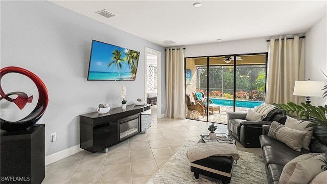 tiled living room featuring ceiling fan