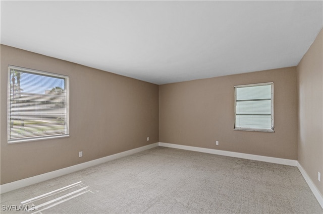 unfurnished room featuring carpet