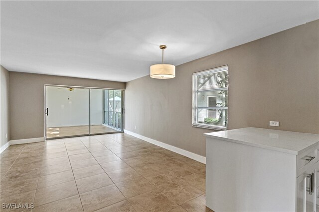 empty room featuring ceiling fan and light tile patterned floors