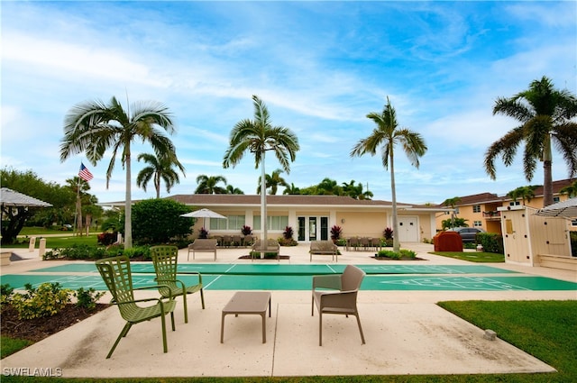 view of swimming pool with a patio and french doors