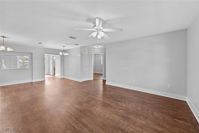 unfurnished living room featuring dark hardwood / wood-style flooring and ceiling fan with notable chandelier