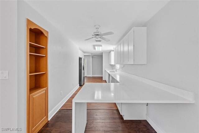 interior space featuring sink, dark hardwood / wood-style floors, and built in shelves