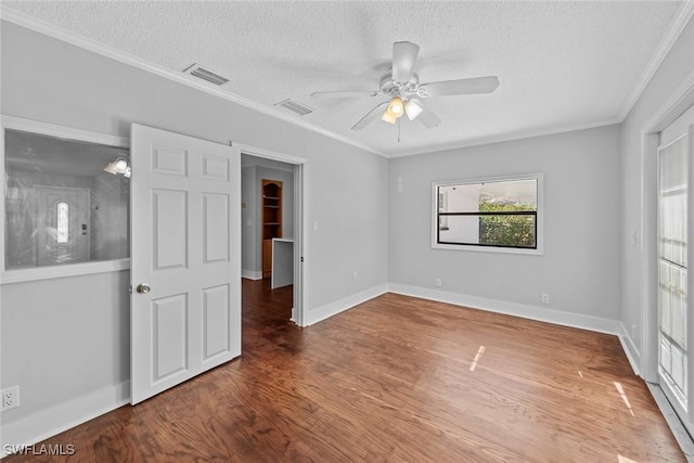 unfurnished bedroom with hardwood / wood-style flooring, ceiling fan, crown molding, and a textured ceiling