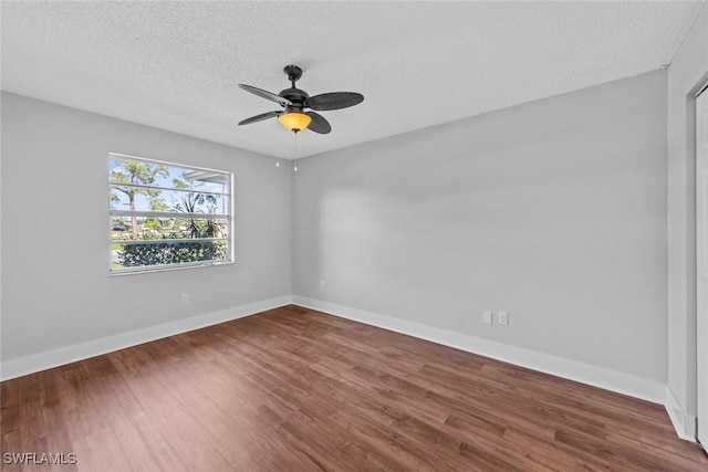 spare room with ceiling fan, hardwood / wood-style flooring, and a textured ceiling