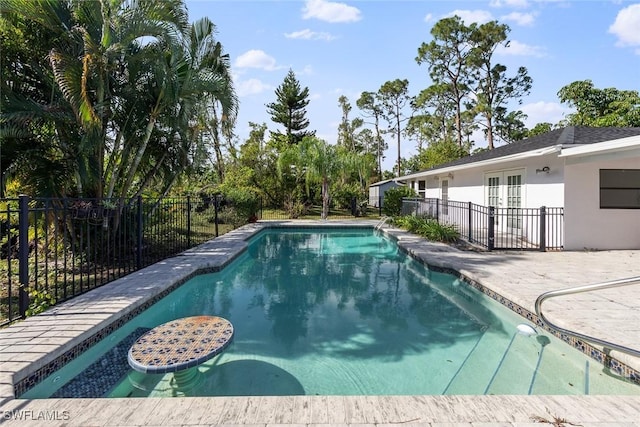 view of pool featuring a patio and french doors