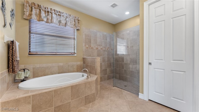 bathroom featuring tile patterned flooring and independent shower and bath