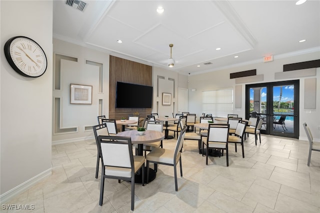 dining space with crown molding and french doors