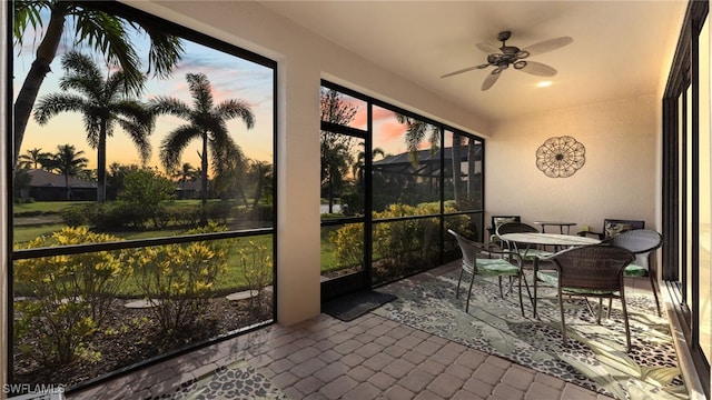 sunroom / solarium featuring ceiling fan