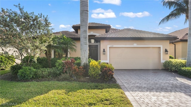 view of front of house with a garage and a front yard