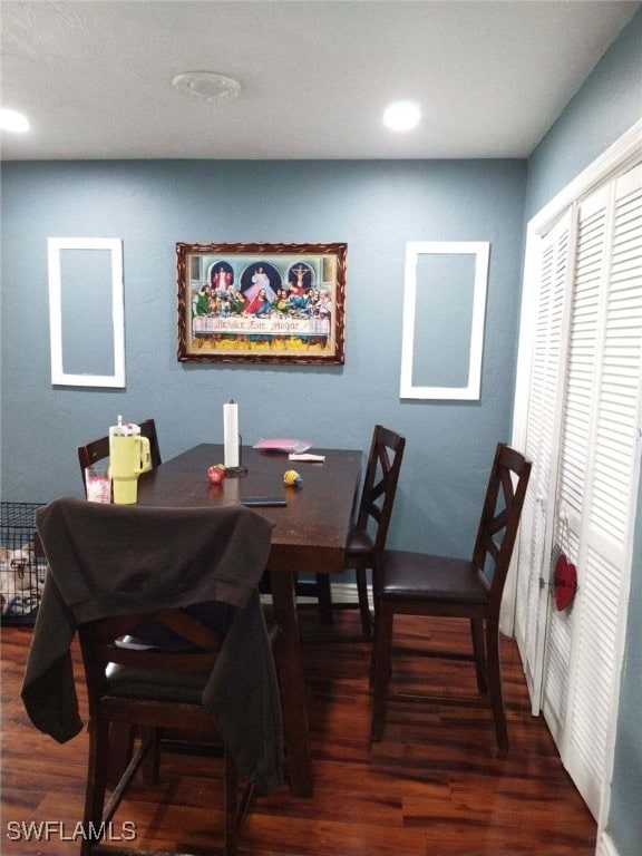 dining space featuring dark wood-type flooring