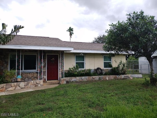 ranch-style house with a front lawn