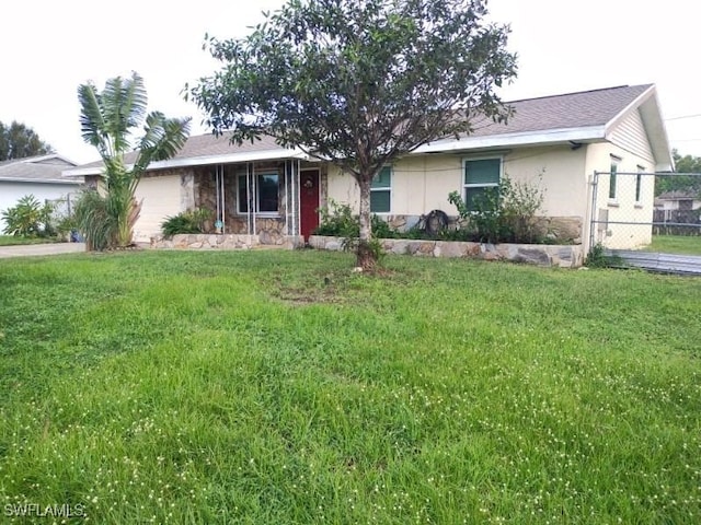 ranch-style home featuring a front yard