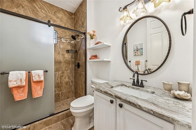 bathroom featuring vanity, an enclosed shower, and toilet