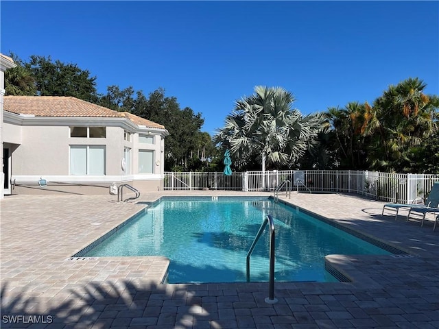 view of swimming pool featuring a patio area