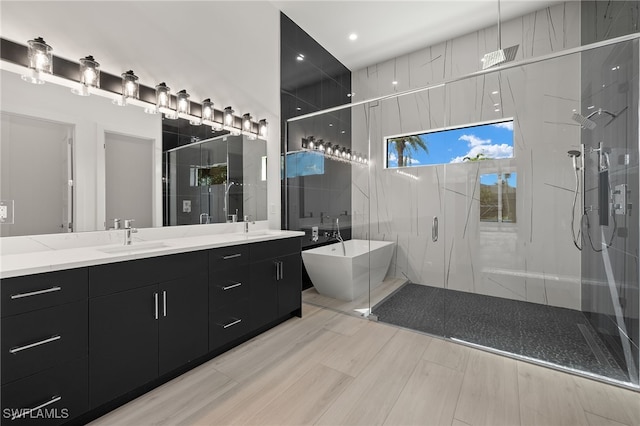 bathroom featuring vanity and shower with separate bathtub