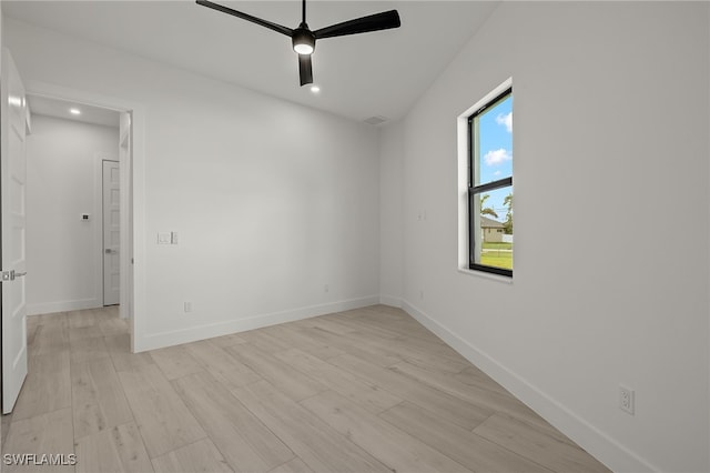 spare room with light wood-type flooring and ceiling fan