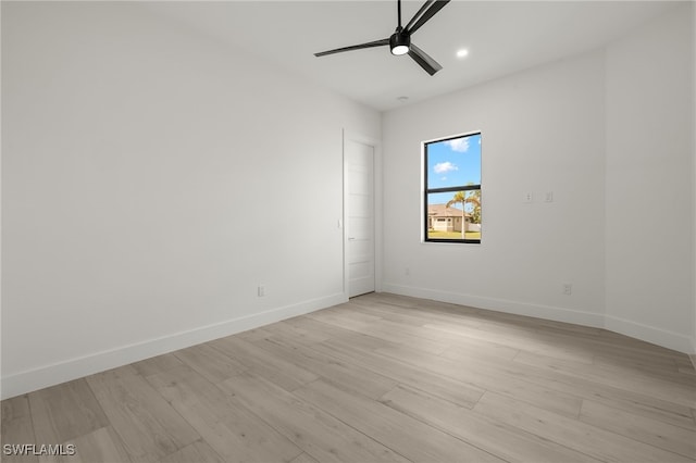 empty room with light hardwood / wood-style flooring and ceiling fan