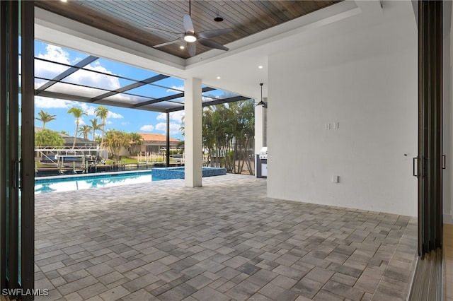 view of swimming pool featuring a patio area, a lanai, and ceiling fan