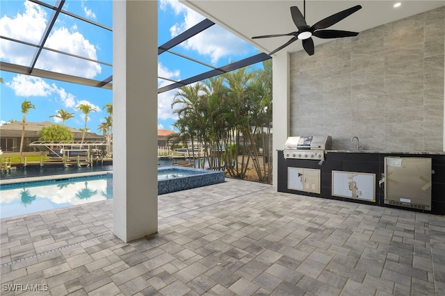 view of patio / terrace featuring a pool with hot tub, ceiling fan, glass enclosure, area for grilling, and sink