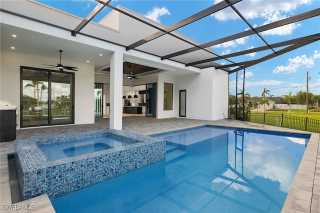 view of swimming pool with an in ground hot tub, ceiling fan, a lanai, and a patio