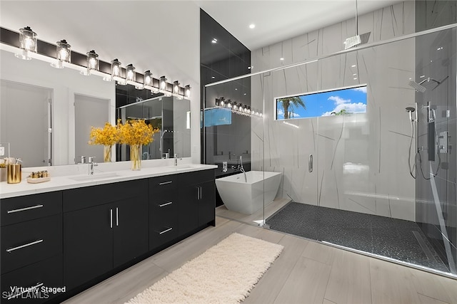 bathroom with vanity and independent shower and bath