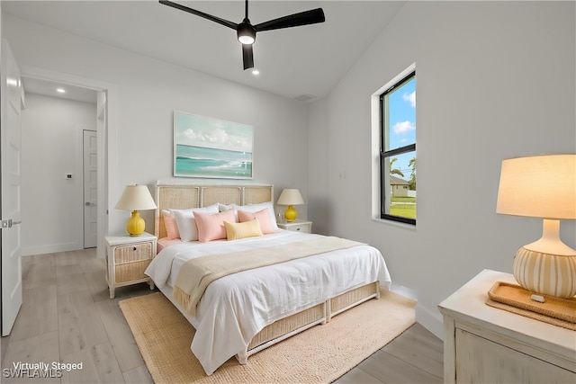 bedroom with light hardwood / wood-style flooring and ceiling fan