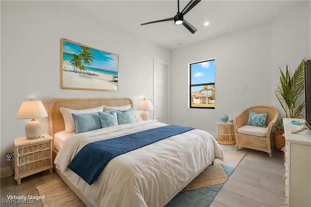 bedroom featuring light hardwood / wood-style floors and ceiling fan