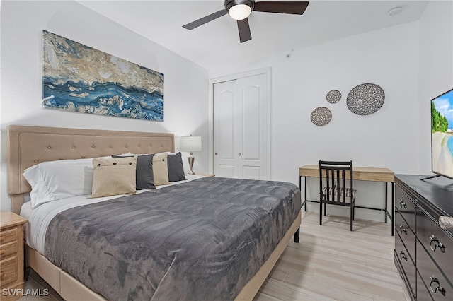 bedroom featuring ceiling fan, light hardwood / wood-style floors, and a closet