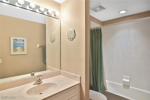 full bathroom featuring shower / bath combination with curtain, vanity, and toilet