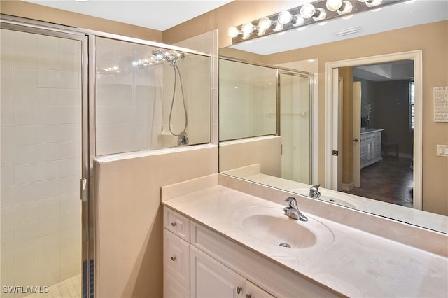 bathroom with vanity and a shower with shower door