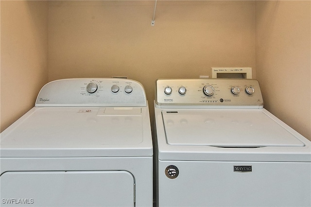 clothes washing area featuring washer and clothes dryer