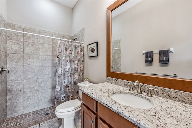 bathroom with vanity, toilet, a shower with shower curtain, and tile patterned floors