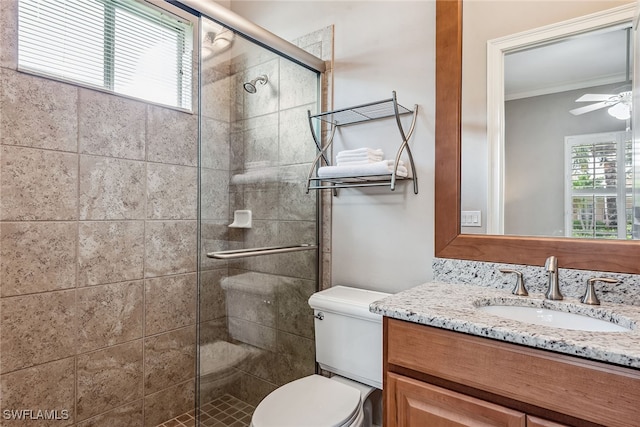 bathroom with walk in shower, vanity, toilet, and ceiling fan